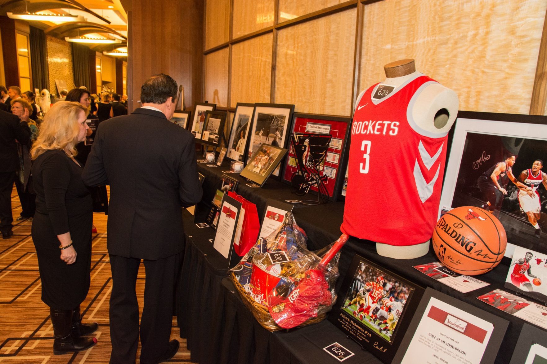 Attendees look at some of the many auction items
